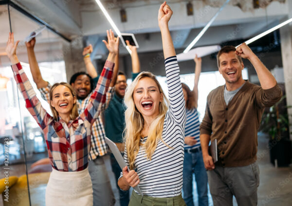 Happy business people celebrating success at company